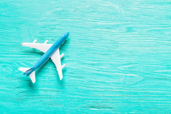 Miniature airplane on colourful background for travel theme