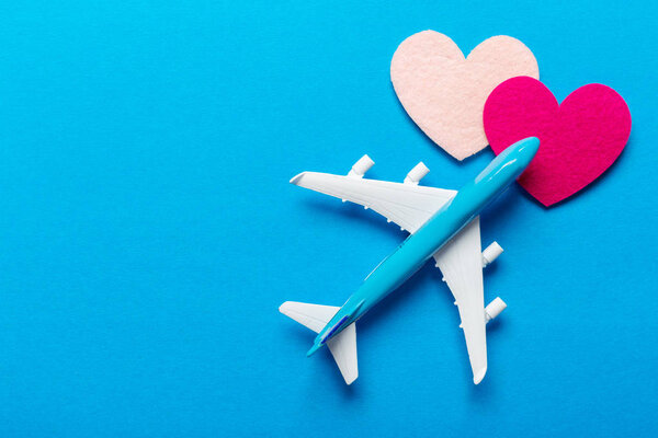 Closeup of miniature airplane on colored background. Travel or vacation concept