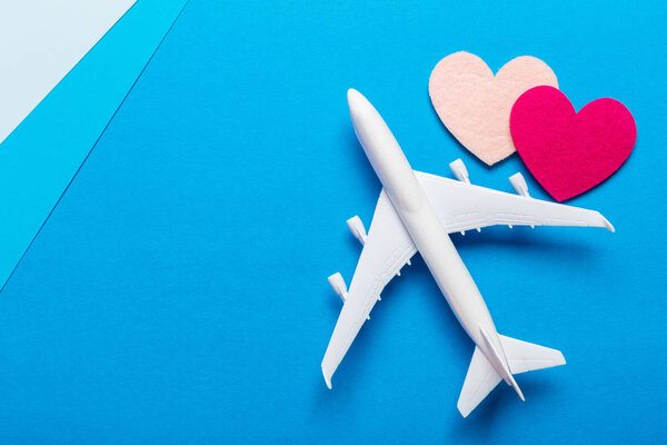 Closeup of miniature airplane on colored background. Travel or vacation concept