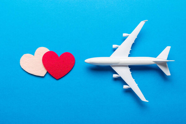 Closeup of miniature airplane on colored background. Travel or vacation concept