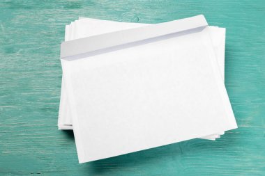 ahşap masa üzerinde beyaz zarfları