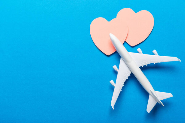 Closeup of miniature airplane on colored background. Travel or vacation concept