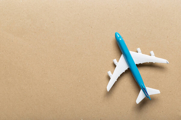 Closeup of miniature airplane on colored background. Travel or vacation concept