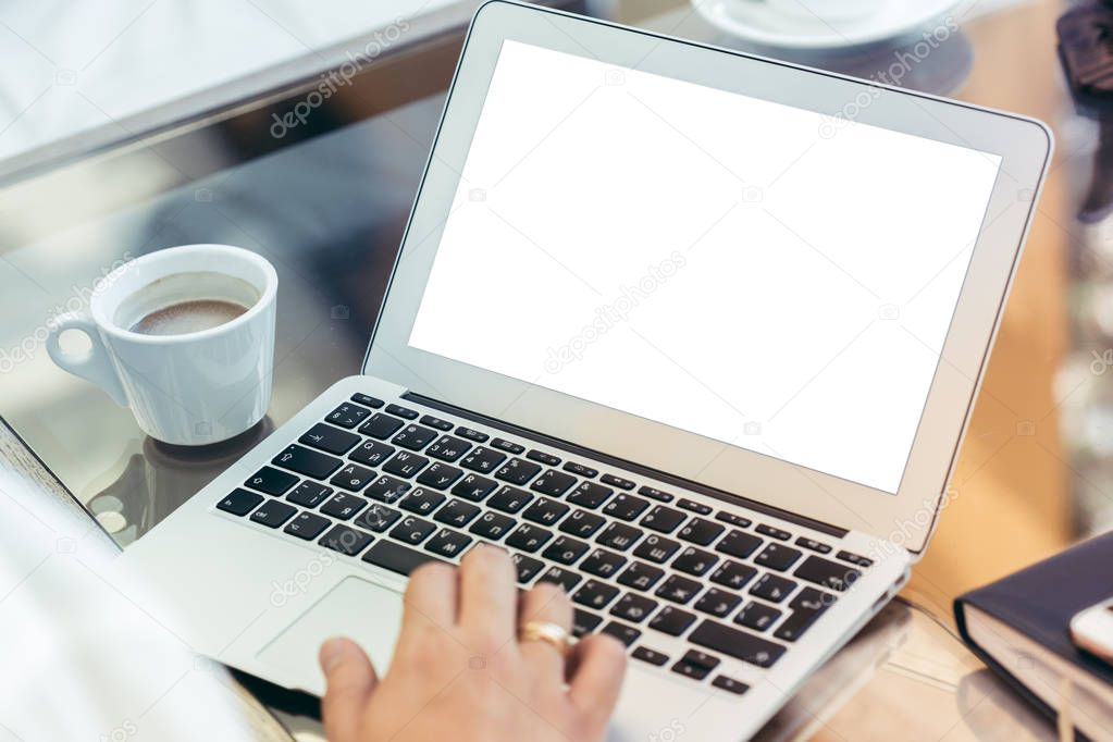 Young man performs work on a laptop