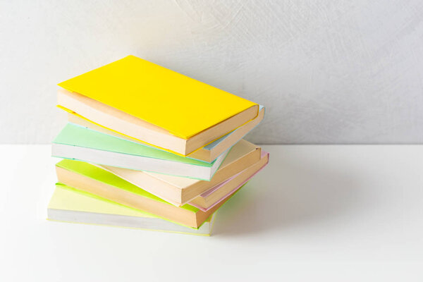  pile of paperback books on a table