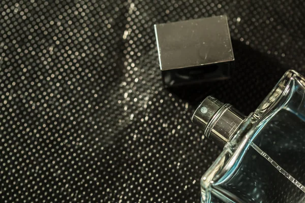 A bottle of men\'s perfume on a dark background.