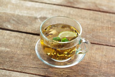 Ahşap masanın üstüne nane aromalı çay yaprakları