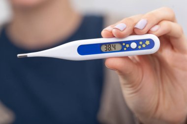 Sick woman with a thermometer clipart