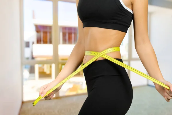 Female fitness body with a tape