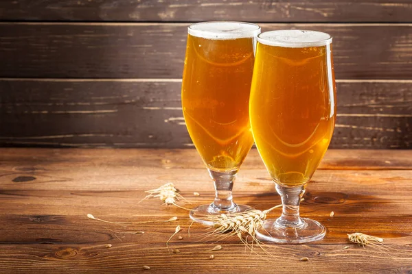 glasses of beer on wooden background