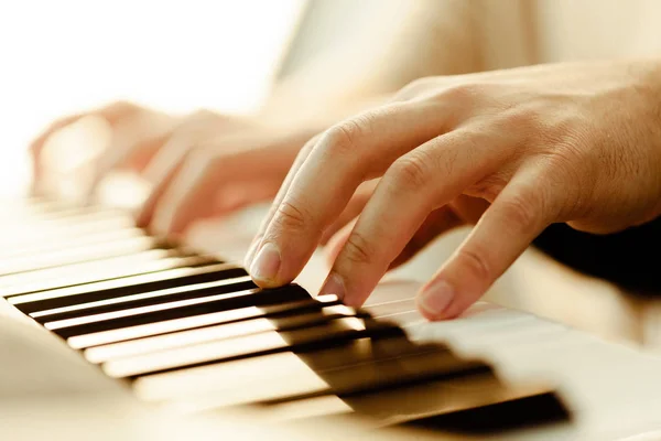 Closeup of hands playing piano. Music and hobby concept.