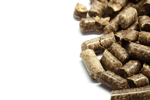 stack of wooden pellets for bio energy, white background, isolated.