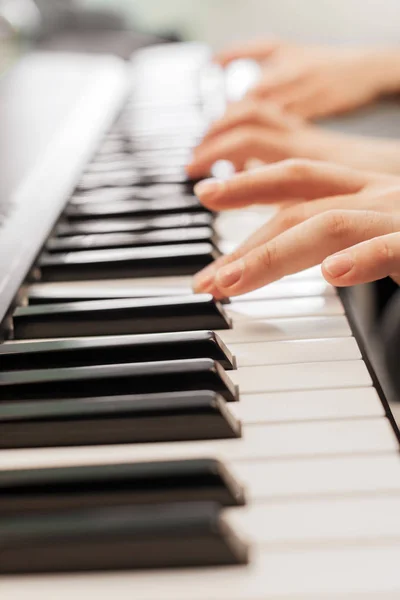 Closeup of hands playing piano. Music and hobby concept.
