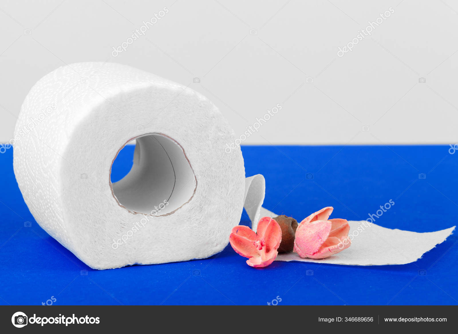 Pastel pink toilet paper rolls on black wooden background Stock