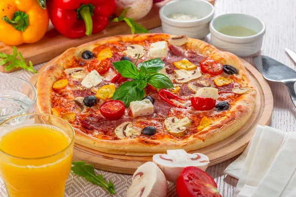 Pizza with Mozzarella, Ham, Cherry Tomatoes, Black Olives