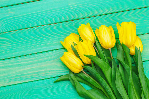 Womens day. Tulips bouquet on wooden planks background, copy space, top view. creative photo.