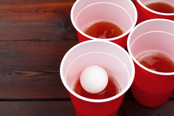 Cups for game Beer Pong on the table. Creative photo.