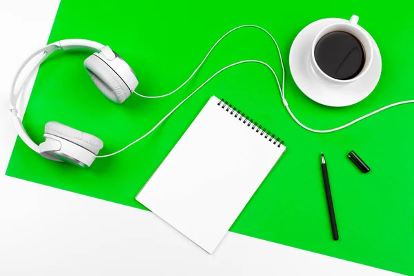 White headphones with cord on bright green background — Stock Photo, Image