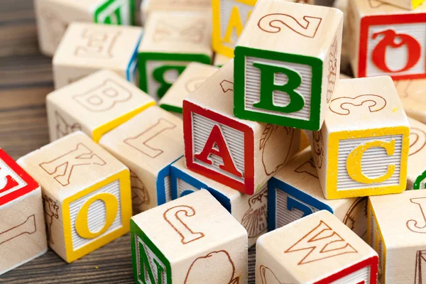 Alphabet blocks ABC on wooden table. creative photo.