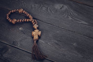 wooden cross on wood background. creative photo.