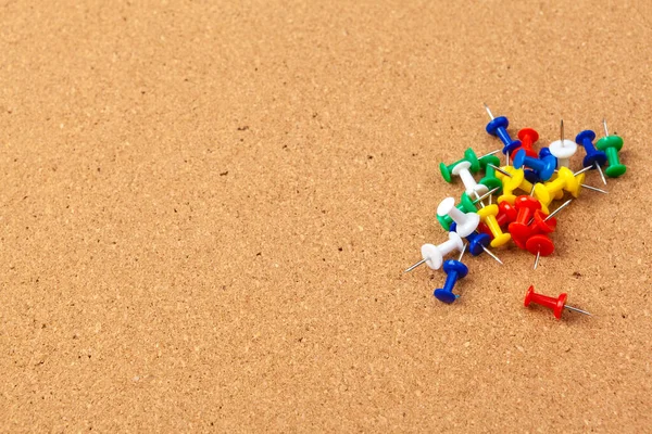 Groep kleurrijke push pinnen op kurk prikbord — Stockfoto