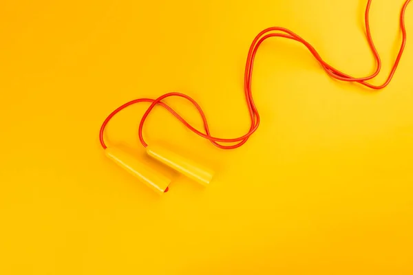 Jumping rope on yellow background. creative photo. — Stok fotoğraf
