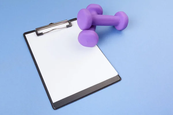 Mockup clipboard with Gym equipment dumbbell on blue background