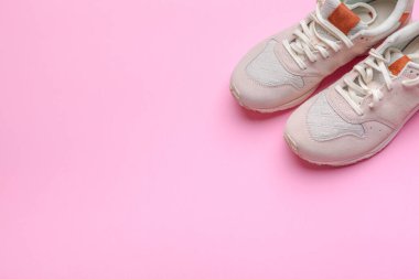 sneakers on pink background. close up. creative photo.