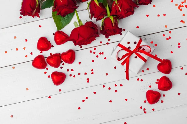 Valentinstag. Rote Rosen und Geschenkbox auf Holztisch — Stockfoto