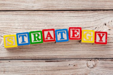 Wooden toy Blocks with the text: strategy