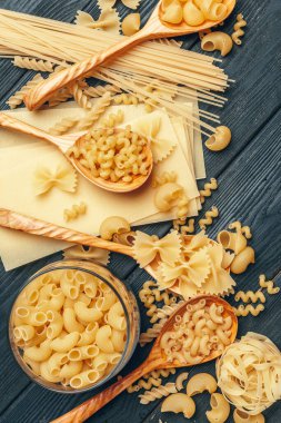Various pasta on spoons. close up. creative photo.