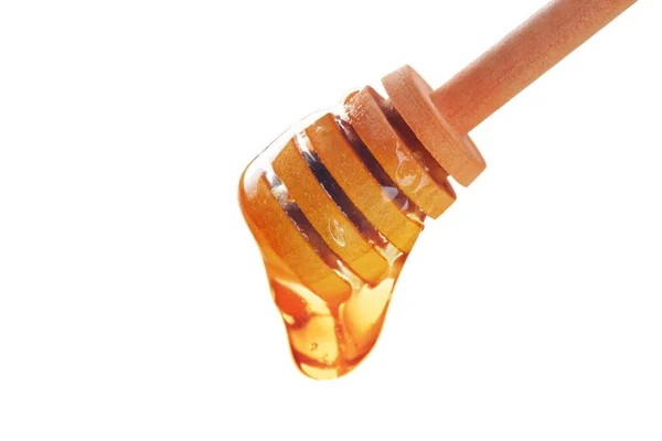 Медова паличка з медом, що тече, ізольована на білому тлі — стокове фото