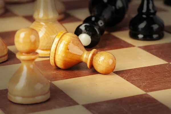 Шахові фігури на дерев'яній шахівниці на темному тлі — стокове фото