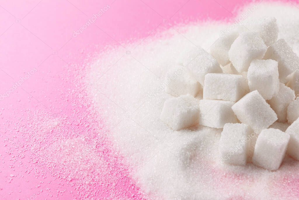 Cubes of sugar on bright pink background