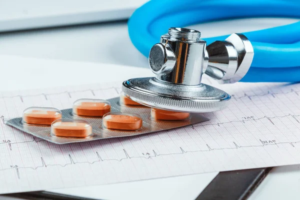 Stethoscope on cardiogram sheet. close up. creative photo.