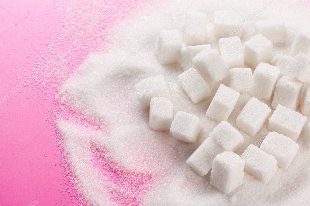 Cubes of sugar on bright pink background