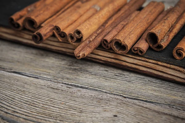 Cinnamon sticks on wooden background. creative photo. — Stock Photo, Image