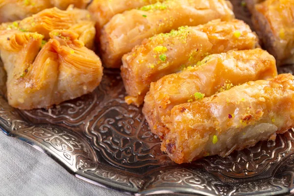 Turkish sweets baklava and metal oriental tray on wooden background — Stock Photo, Image