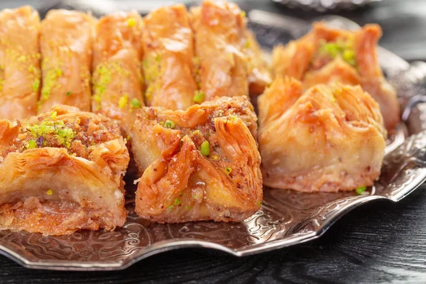 Turkish arabic dessert baklava with honey and nuts on a silver plate — Stock Photo, Image