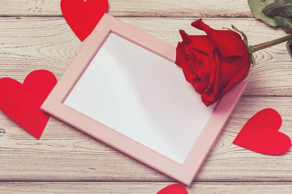 Valentines day photo frame or greeting card and handmaded hearts over table. Top view with copy space — Stock Photo, Image