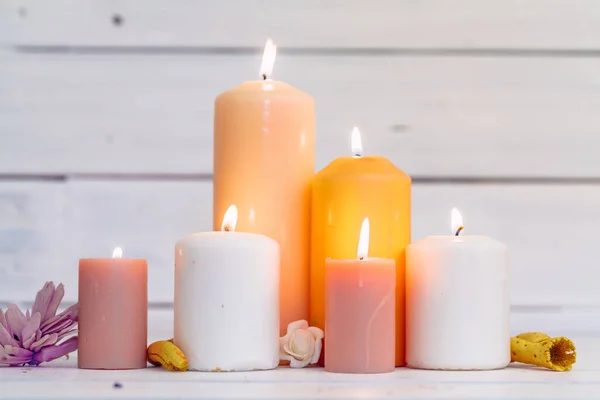 Home lighting candles on wooden table. Close up. — Stock Photo, Image
