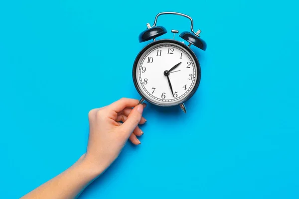 Black vintage alarm clock on color background — Stock Photo, Image