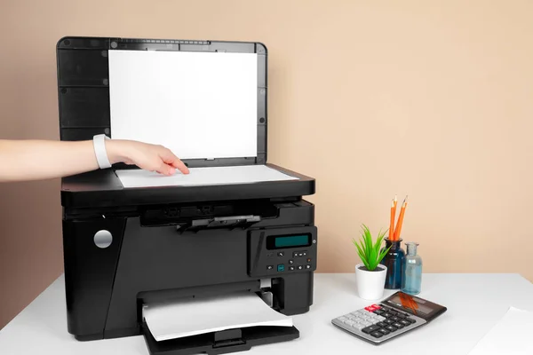 Woman using the printer to scanning and printing document