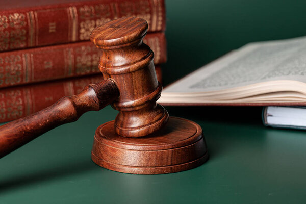 Close up of a brown wooden gavel and book