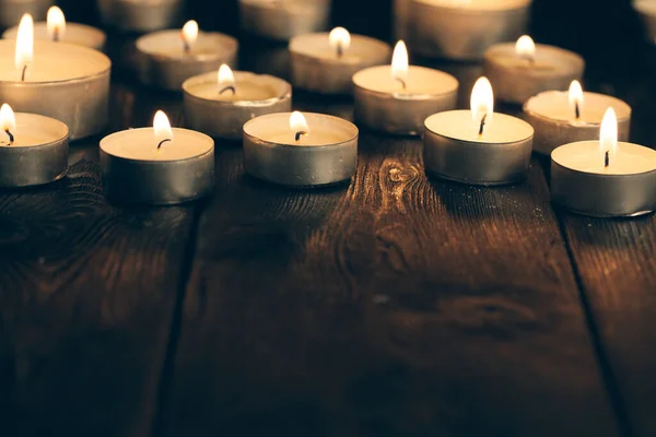 Candles burning in darkness over black background. commemoration concept. — Stock Photo, Image