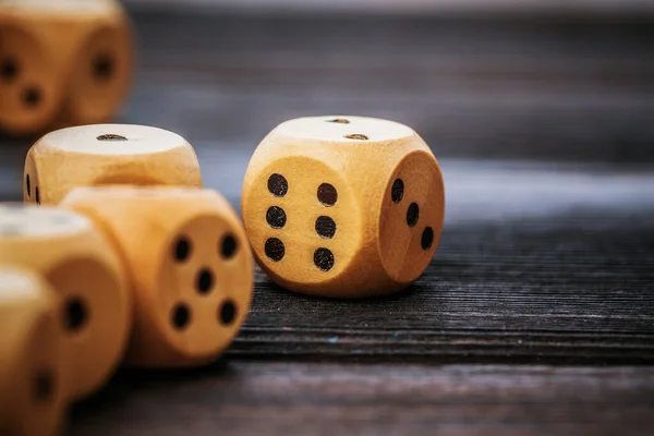 Dice on wooden table. Background for casino games.