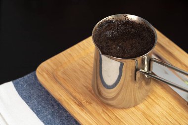 Mutfak tezgahında metal bir Türk 'ün içinde demlenmiş kahve.