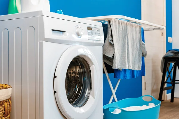 Laundry room interior with washing machine and clothes dryer near wall — Stock Photo, Image