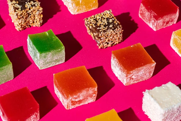 Turkish delight square pieces on a bright pink background — Stock Photo, Image