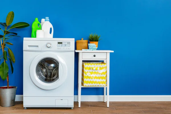 Bottle of detergent whith washing machine, indoors